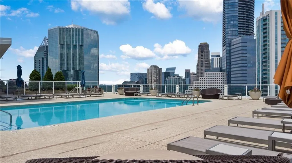 Community pool with a patio and a skyline view