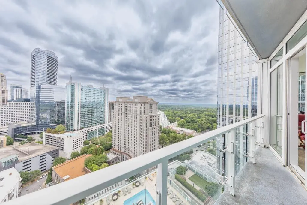 Balcony with view of pool and a view of city