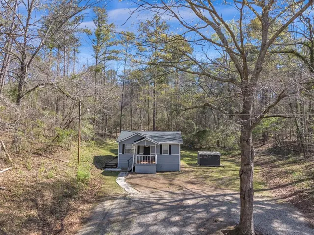 View of front of house featuring a wooden deck