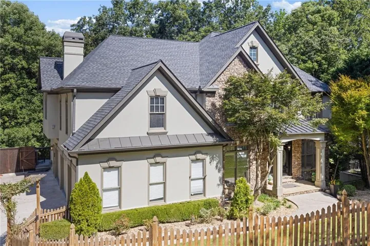 Stucco and stone exterior with multi-gabled roofline