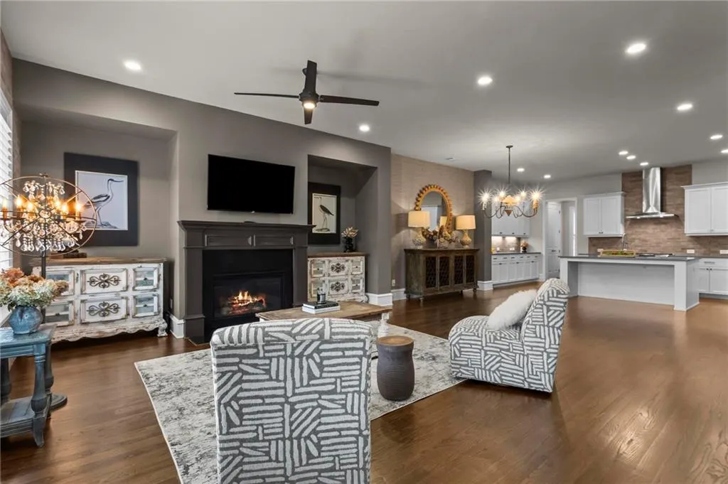 Breathtaking! Gleaming hardwoods and brick accent walls