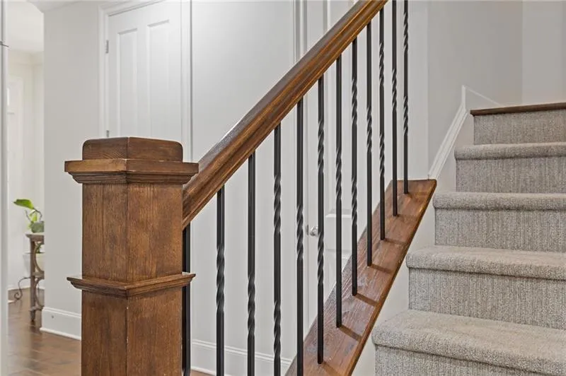 Iron stair rails and recently installed luxury carpet