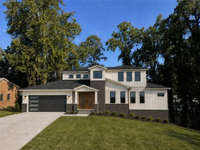 Contemporary exterior with vertical panel siding and dark brick accents