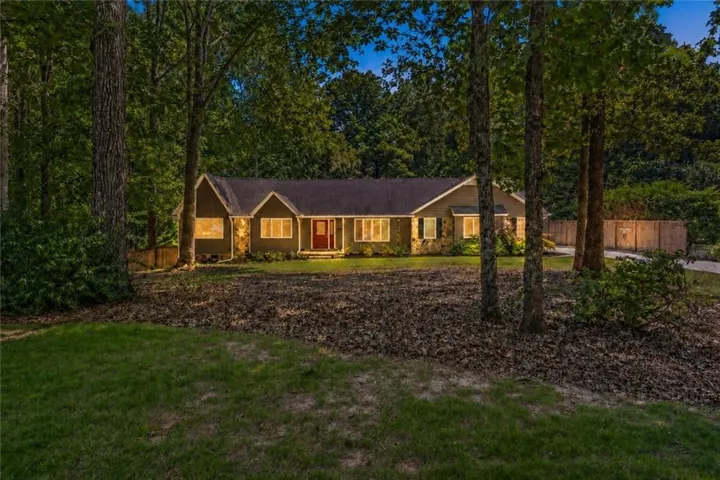 Stone and siding exterior with a dark shingle roof