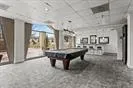 Recreation room with billiards table and concrete flooring