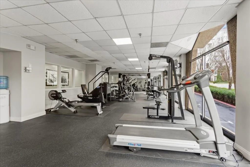 Workout area featuring baseboards and a paneled ceiling