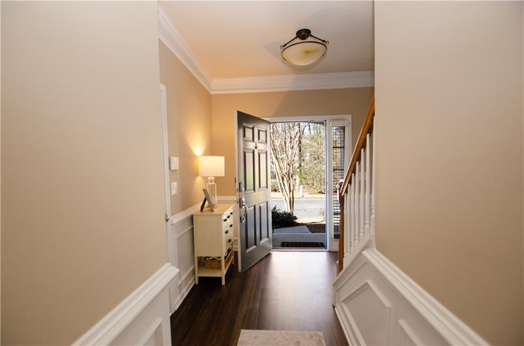 Foyer featuring dark hardwood flooring and ornamental molding Foyer featuring dark hardwood flooring and ornamental molding