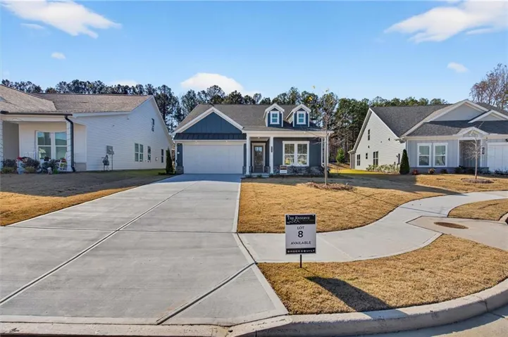 Craftsman-style exterior with a two-car garage, stone accents, and dormer windows