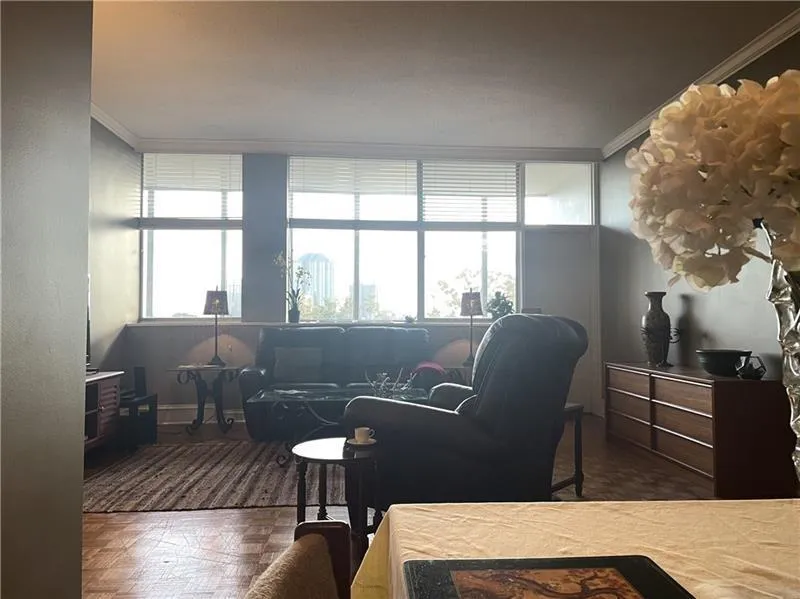 Living room with a wall of windows and oak parquet floors