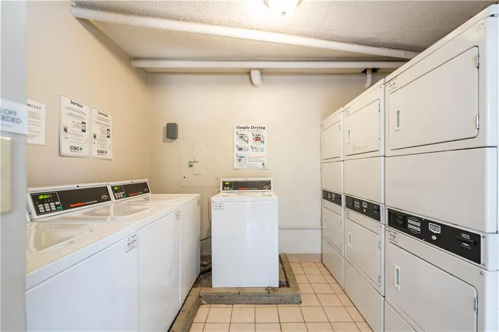 Common laundry area featuring washer and clothes dryer and stacked washer and clothes dryer