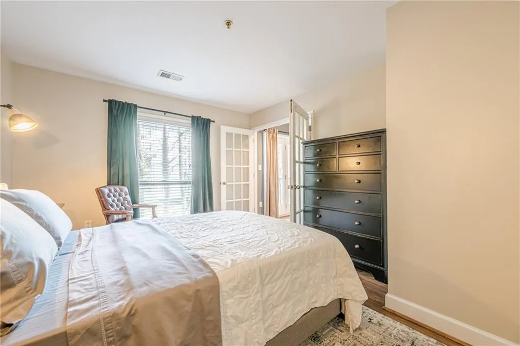 Bedroom with wood finished floors and baseboards
