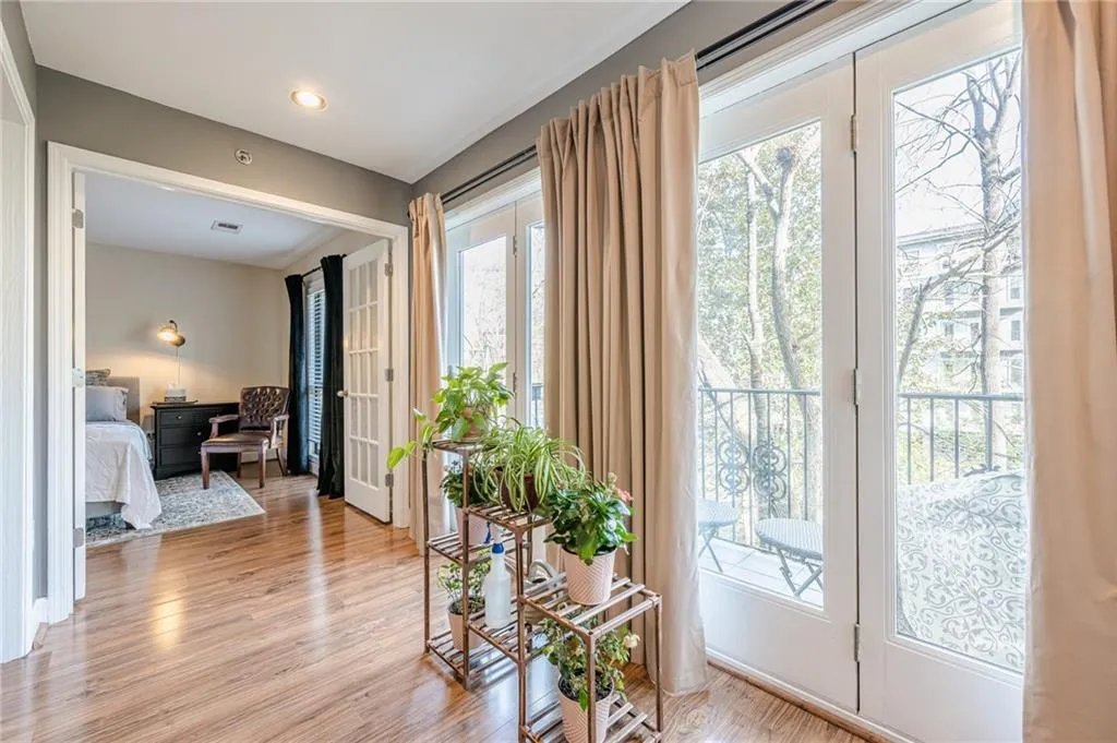 Doorway with plenty of natural light, french doors, and light wood-style floors