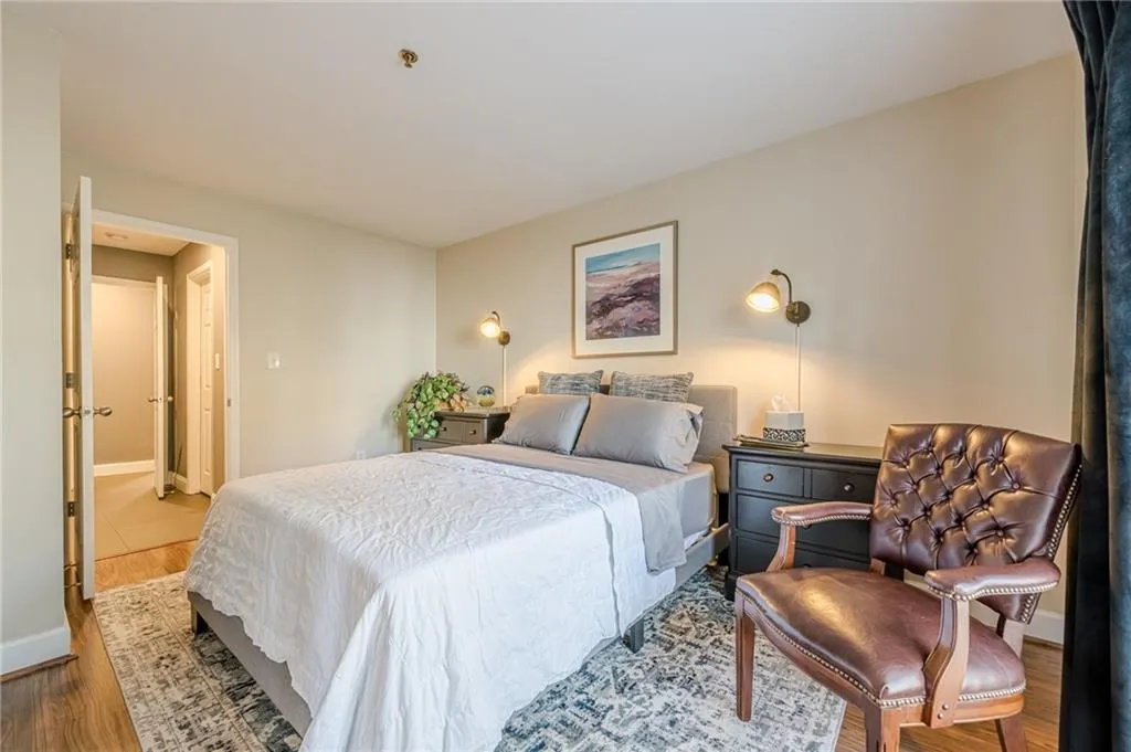 Bedroom featuring wood finished floors and baseboards
