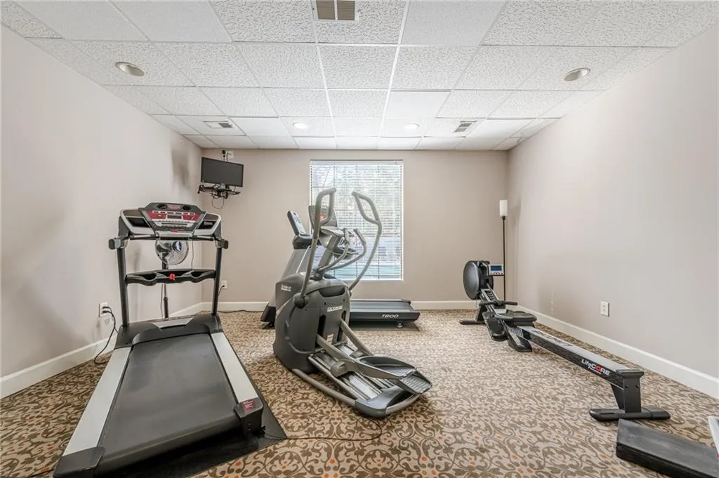 Exercise area with carpet and a drop ceiling