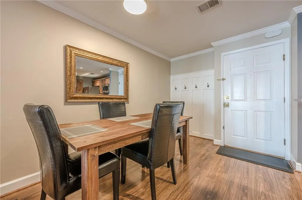 Dining area with light wood-style flooring and ornamental molding