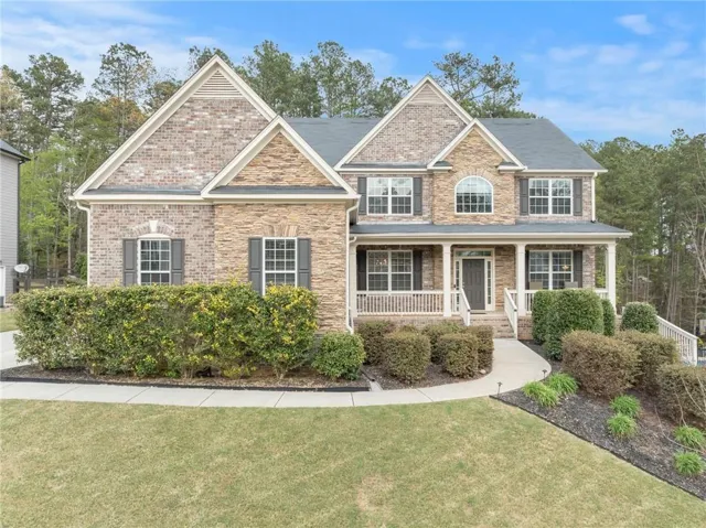 Traditional-style residence featuring a stone and brick facade