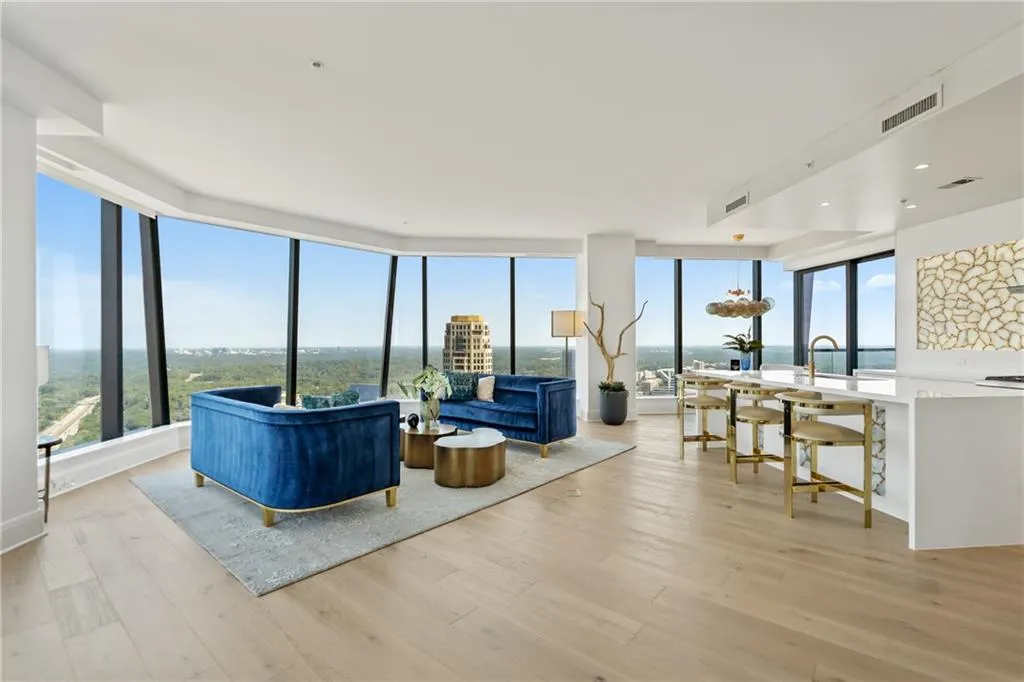 Living room featuring expansive windows and light wood-style floors