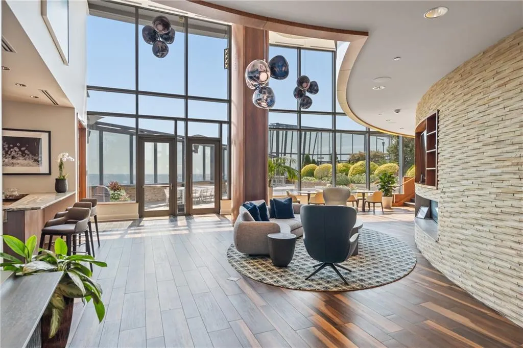 Common area featuring floor to ceiling windows, recessed lighting, and a towering ceiling