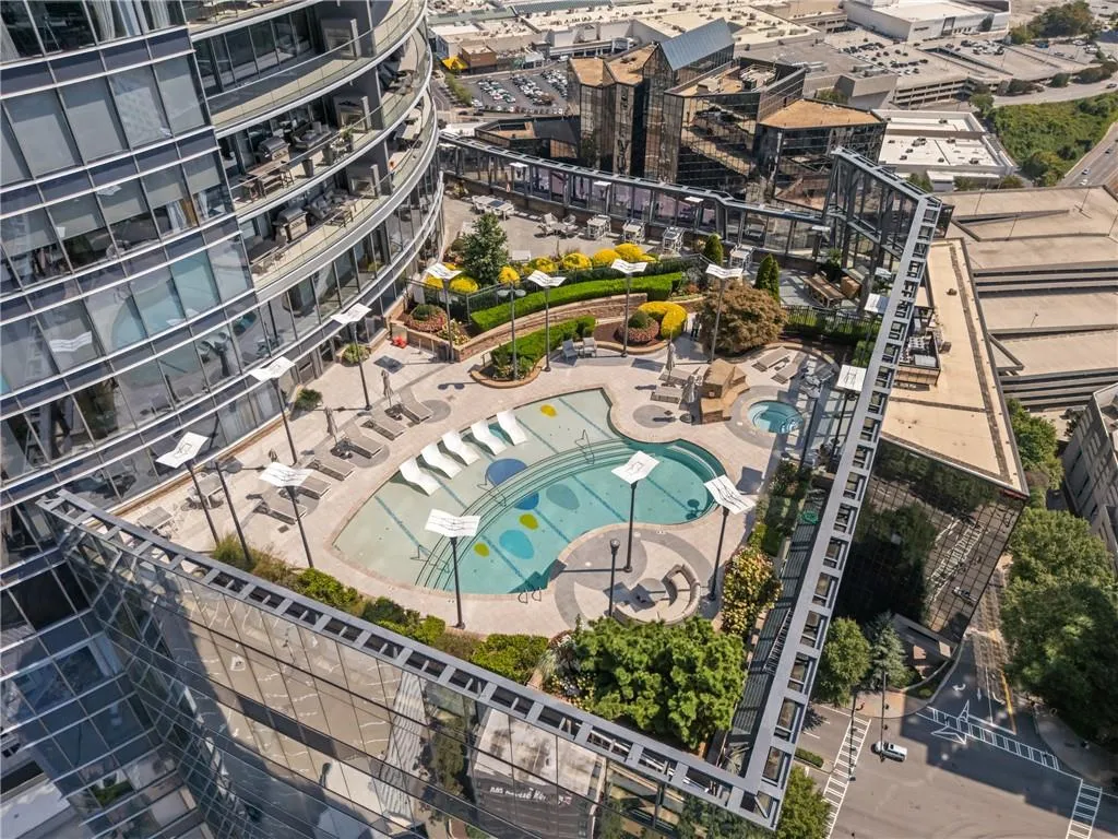 Aerial view of property and surrounding area with a pool