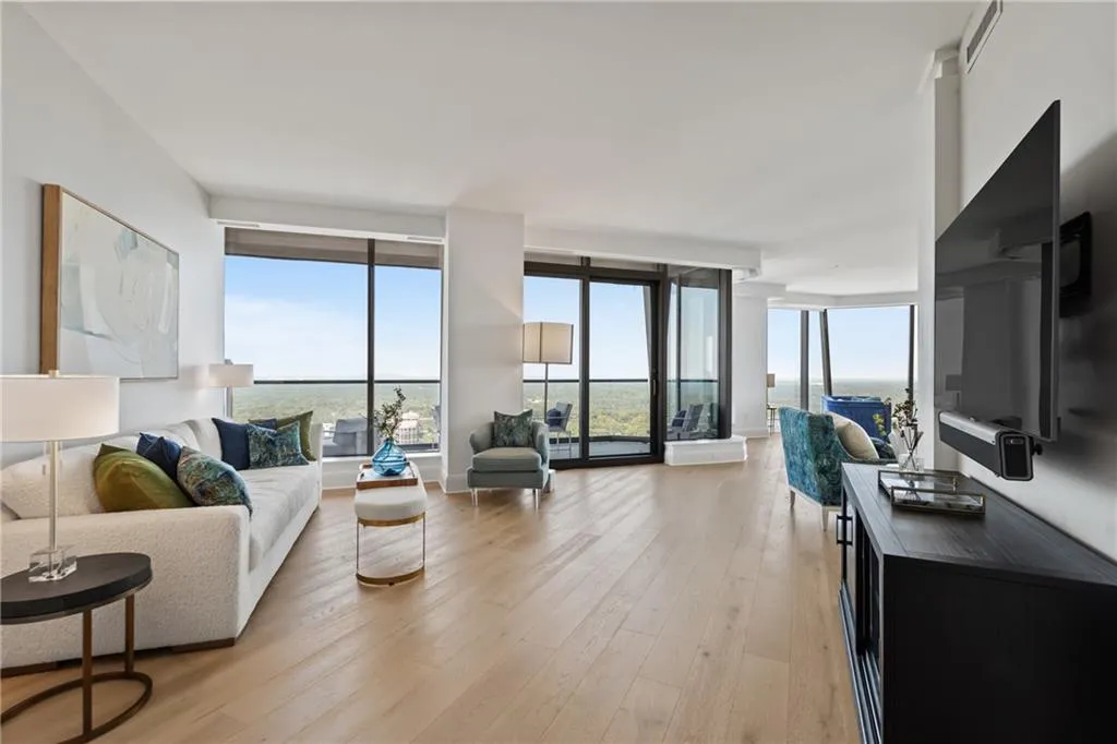 Living area featuring light wood-style floors and a wall of windows