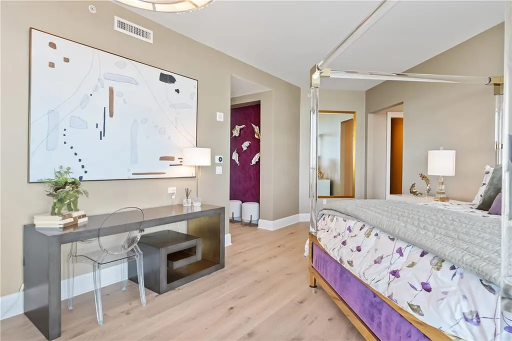Bedroom with light wood finished floors and baseboards