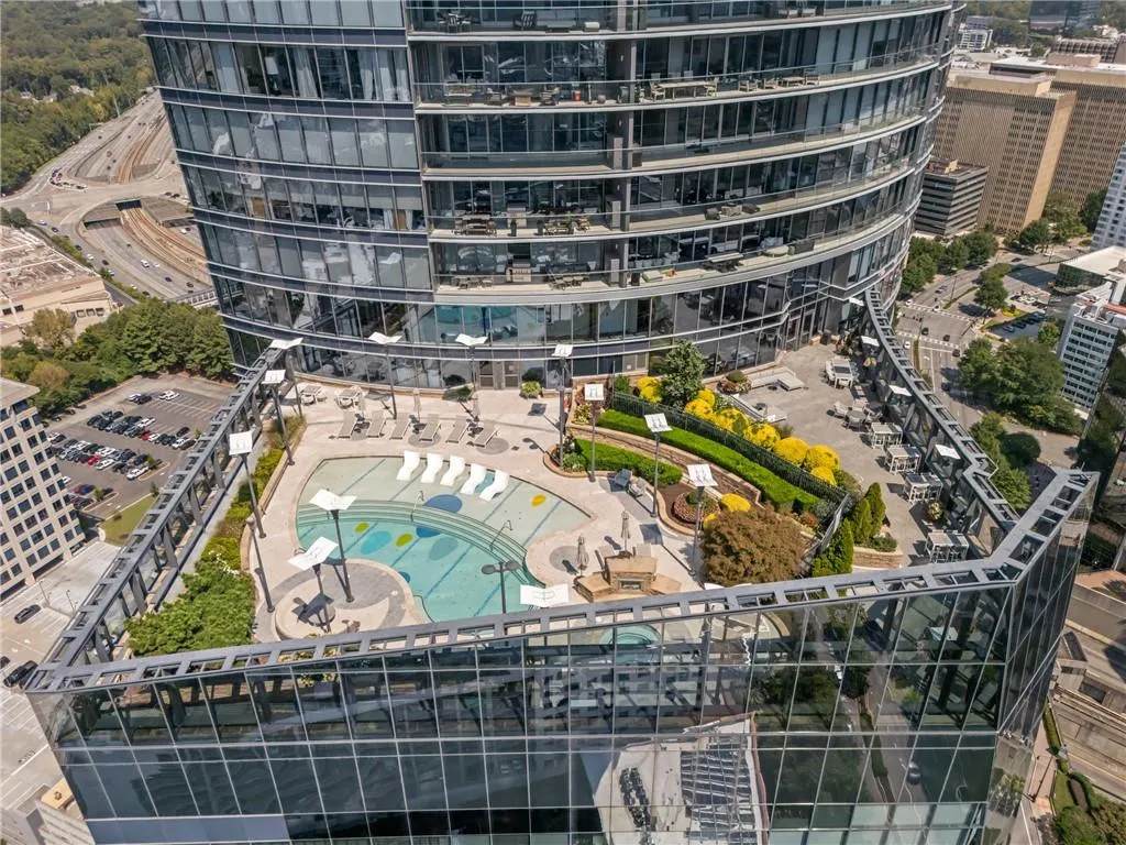 Aerial overview of property's location with apartment complex and a pool area