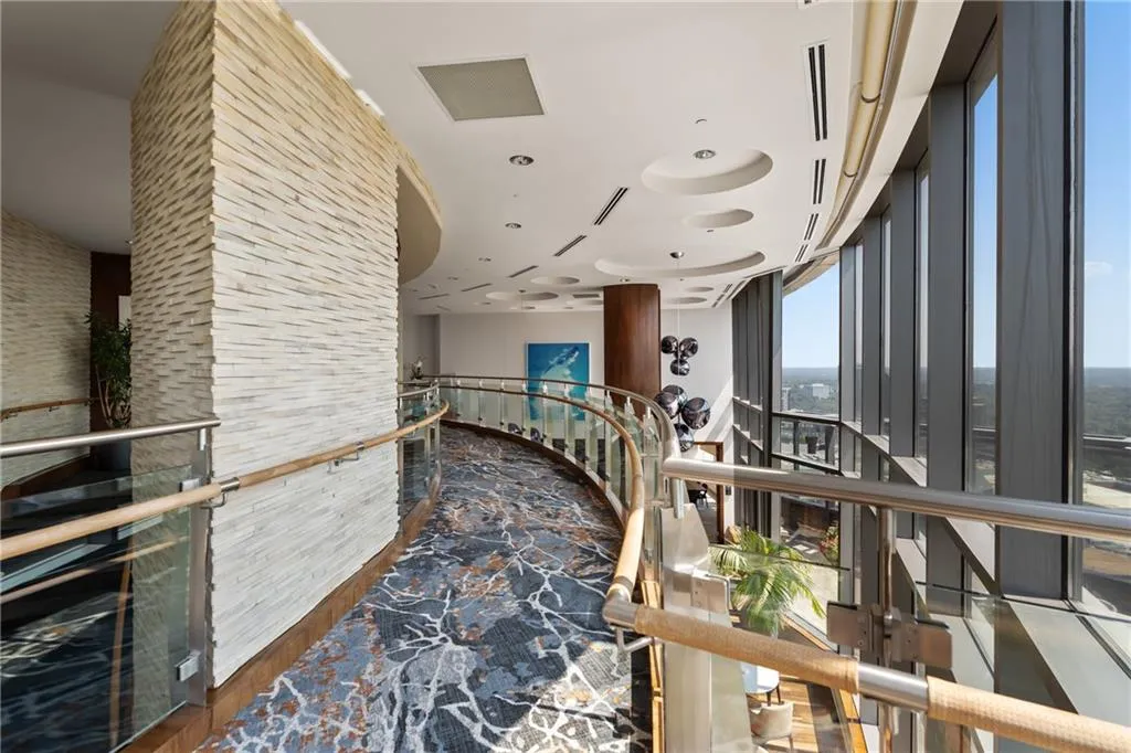 Hall featuring an upstairs landing and dark wood-style flooring