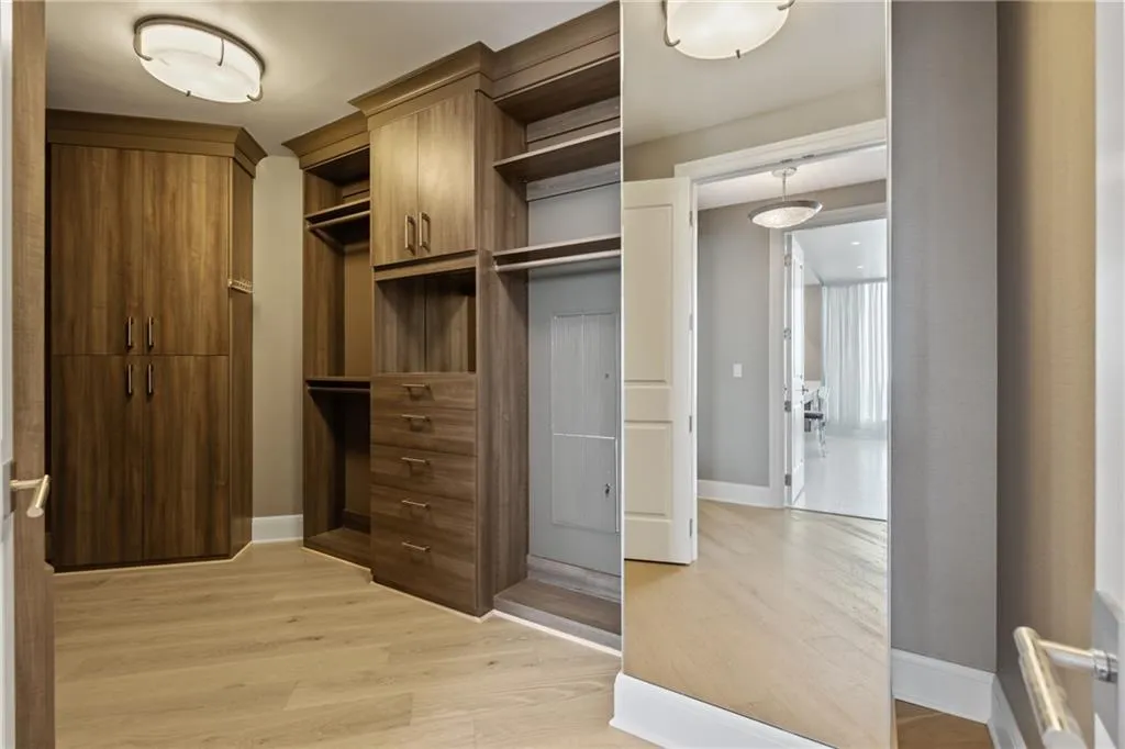 Walk in closet featuring light wood-style flooring
