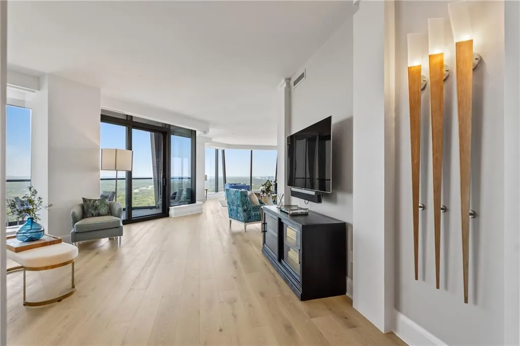Living room with expansive windows and light wood-style flooring