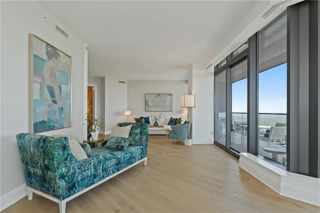 Living area featuring light wood-style floors and baseboards