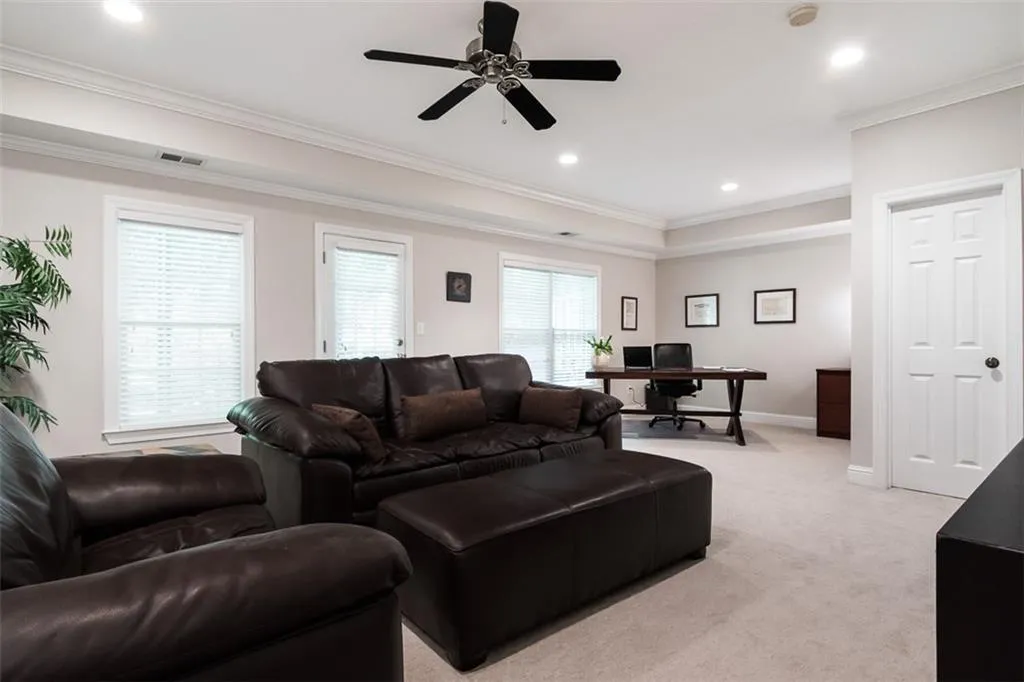 Terrace level makes a fantastic media room and/or office. Wall of windows lets in lots of natural light!. Nice-sized storage closet (door shown).