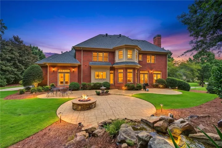 Brick exterior with multiple windows and a bay window feature
