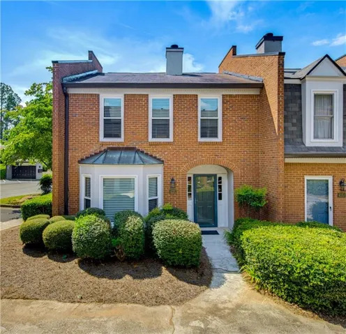 Brick exterior with a prominent bay window featuring a metal roof