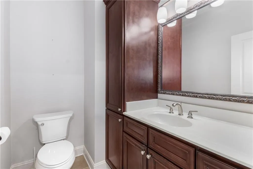Half bath with vanity and light tile patterned floors