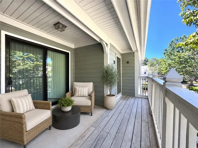 Covered outdoor front balcony that can easily be accessed via the dining room sliding glass doors or front door. Virtually staged image.
