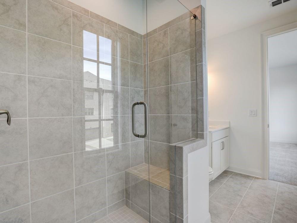 This ensuite bath offers a walk in shower with frameless doors!