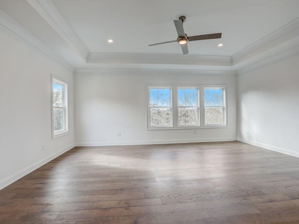 The Primary Suite on the rear of this home has trey ceiling, can lighting and hardwood flooring.