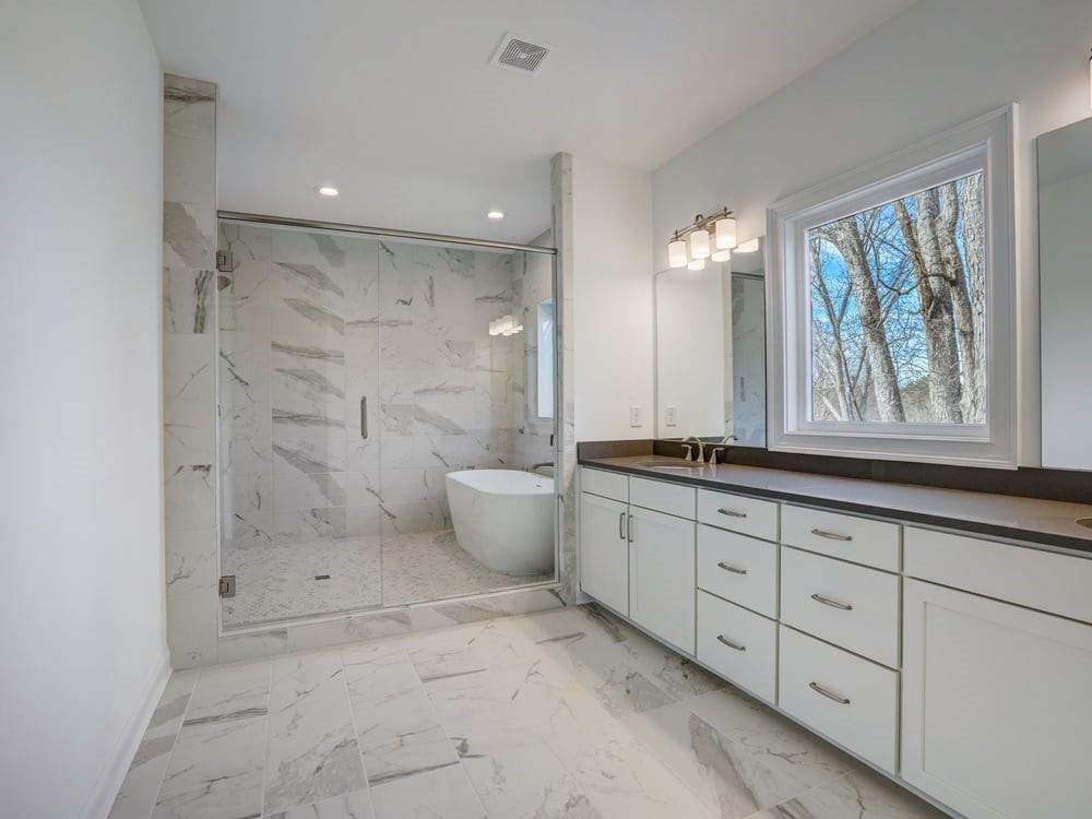 Enjoy the luxurious spa bath featuring tile to ceiling and a free standing tub to indulge!