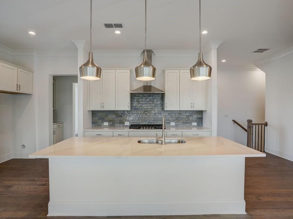 Enjoy this chefs kitchen with amazing quartz and pendant lighting!