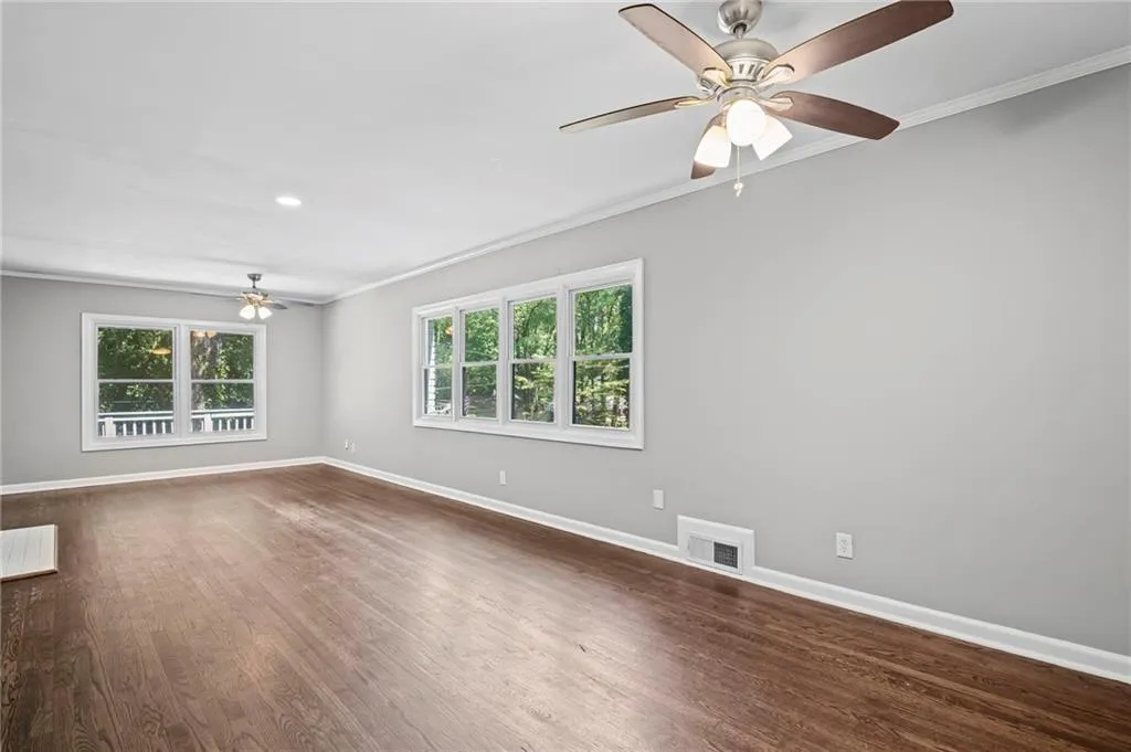 Spare room with a ceiling fan, ornamental molding, dark wood finished floors, and recessed lighting