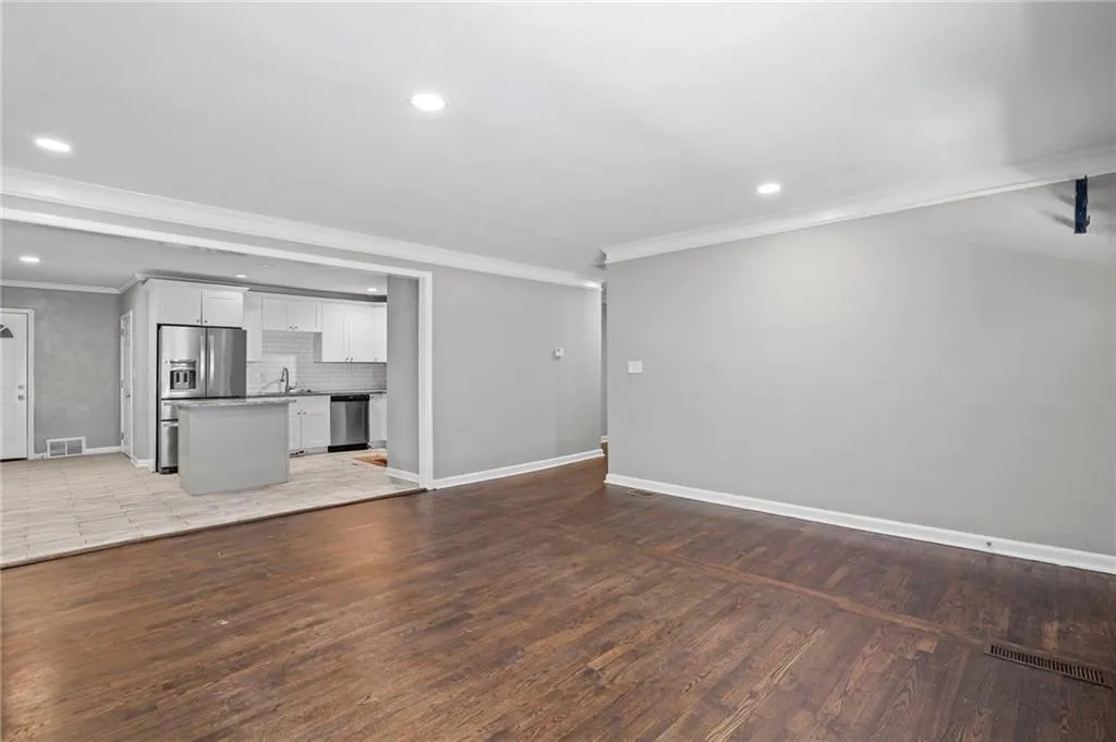 Unfurnished living room featuring crown molding, recessed lighting, and light wood finished floors