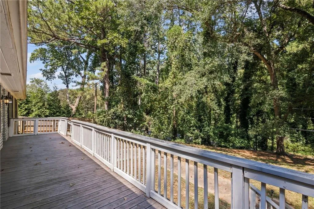 Wooden deck with view of scattered trees