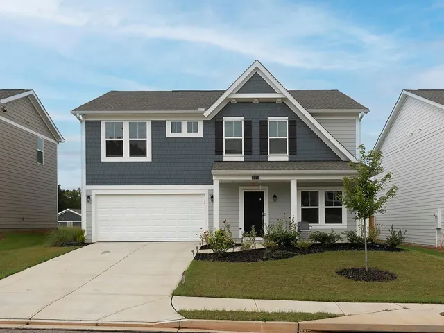 Contemporary-style home featuring gray horizontal siding and blue-gray shake siding accents