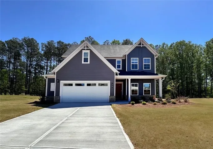 Traditional-style house featuring driveway and a front yard