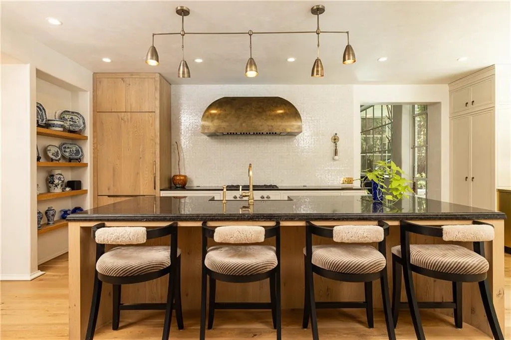 Expansive island provides generous seating and gathering space at the heart of the kitchen.