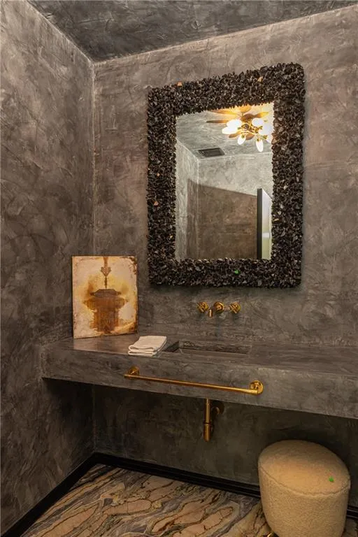 Rich Venetian plaster creates a sophisticated, jewel-box feel in the beautifully appointed powder room.