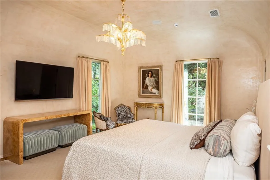 Spacious primary bedroom offers a serene retreat with abundant natural light and access to the outdoors.