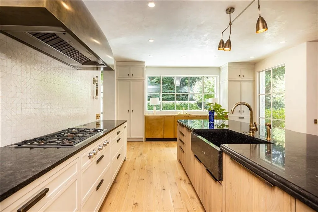 Beautiful marble countertops, custom cabinetry and professional-style appliances create a kitchen designed for serious cooking and entertaining.