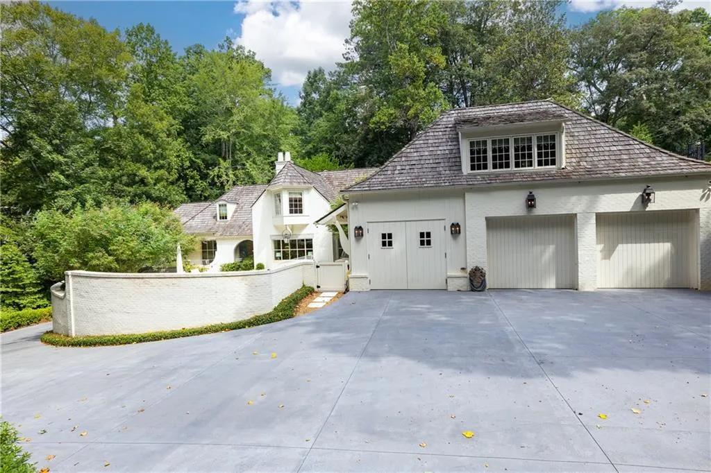 Expansive motor court leads to the three-car garage and provides generous additional parking.