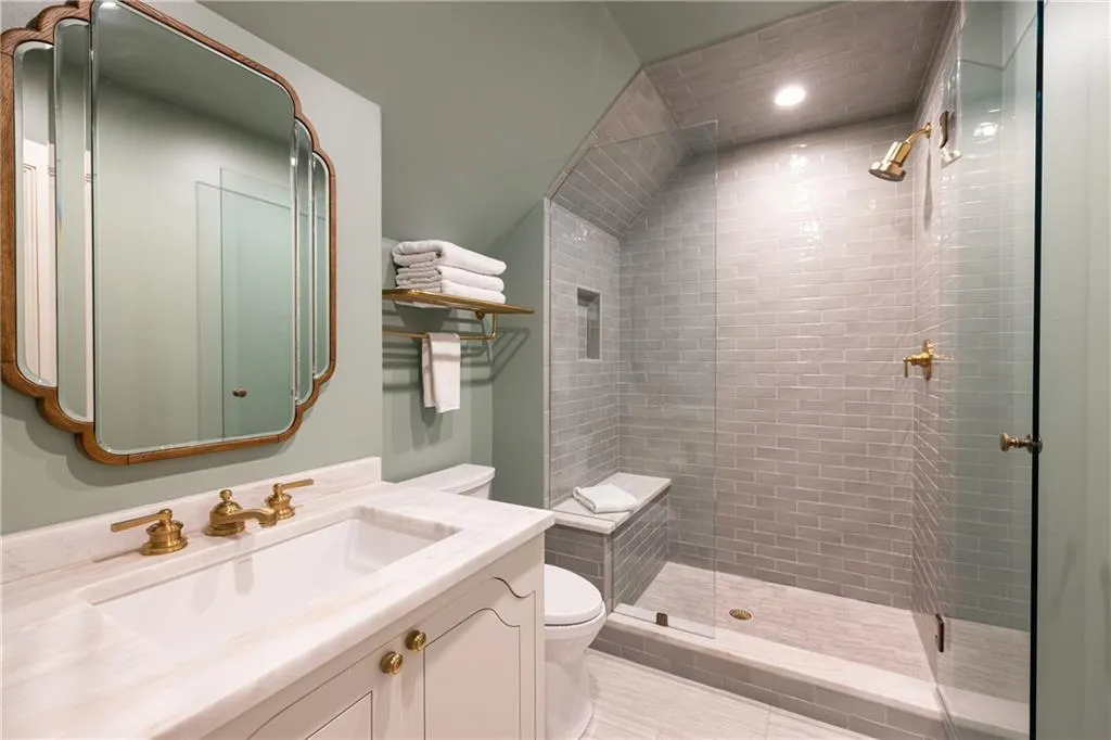 Beautiful ensuite bath offers a spacious vanity and glass-enclosed shower with sophisticated finishes.